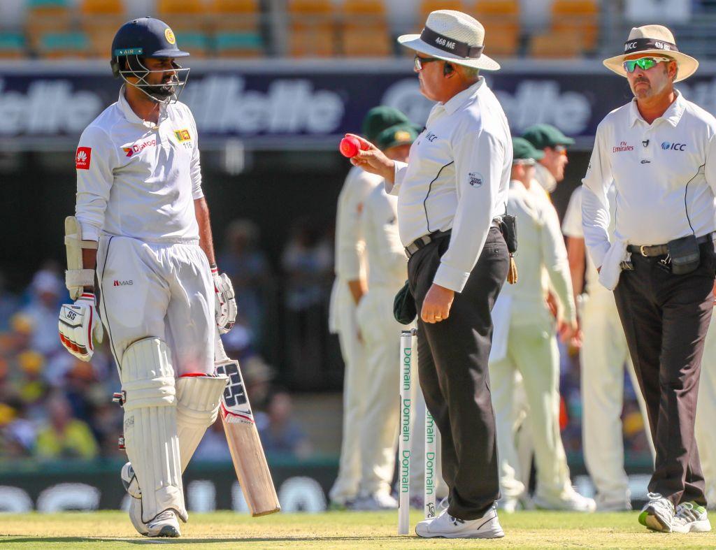 Cricket umpire giving an LBW decision while the batter reviews it using the Decision Review System (DRS).